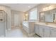 Bright bathroom featuring double sinks, a soaking tub, and a separate glass-enclosed shower at 1511 Hopkins Ln, Mount Pleasant, SC 29466