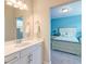 A view into a bathroom featuring a mirror, sink and access to another blue bedroom with carpeted floors at 1511 Hopkins Ln, Mount Pleasant, SC 29466