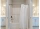 Bright bathroom featuring a shower-tub combo with white tile and neutral walls at 1511 Hopkins Ln, Mount Pleasant, SC 29466