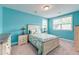 Bright bedroom with coastal decor, including a patchwork quilt, white furniture and blue walls at 1511 Hopkins Ln, Mount Pleasant, SC 29466