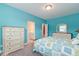 Bright bedroom with coastal decor, featuring a patchwork quilt, white furniture, and light blue walls at 1511 Hopkins Ln, Mount Pleasant, SC 29466