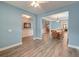 Open-concept dining area with wood flooring, adjacent to a living space, and a dining table at 1511 Hopkins Ln, Mount Pleasant, SC 29466