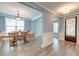 Elegant dining room with wood floors, trim, and an abundance of natural light through the large windows at 1511 Hopkins Ln, Mount Pleasant, SC 29466