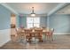 Light-filled dining room with wood table and chairs, featuring elegant lighting and trim at 1511 Hopkins Ln, Mount Pleasant, SC 29466