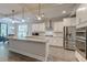 Modern kitchen with stainless steel appliances, granite countertops, white cabinets, and an eat-in island at 1511 Hopkins Ln, Mount Pleasant, SC 29466