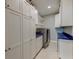 Clean laundry room with white cabinets, blue countertops, and modern washer and dryer at 1511 Hopkins Ln, Mount Pleasant, SC 29466