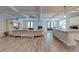 Open-concept living space with a fireplace, leading into a modern kitchen and dining area at 1511 Hopkins Ln, Mount Pleasant, SC 29466