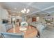 Open concept living room, dining area, and kitchen with coffered ceilings and modern lighting at 1511 Hopkins Ln, Mount Pleasant, SC 29466