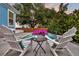 Outdoor pool area with two Adirondack chairs, potted flowers and mature trees at 1511 Hopkins Ln, Mount Pleasant, SC 29466