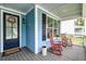 Cozy front porch featuring rocking chairs and a welcoming entrance with blue door at 1511 Hopkins Ln, Mount Pleasant, SC 29466
