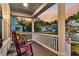 Inviting front porch view with rocking chairs overlooking the neighborhood during a beautiful sunset at 1511 Hopkins Ln, Mount Pleasant, SC 29466