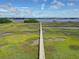 Stunning aerial view of a marsh with long dock leading to the water at 1518 Bower Ln, Johns Island, SC 29455