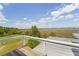 Expansive marsh view from a rooftop deck with modern metal railings and a wooden deck at 1518 Bower Ln, Johns Island, SC 29455