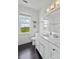 Modern bathroom features white marble countertop, cabinetry, and a window with scenic views at 1518 Bower Ln, Johns Island, SC 29455