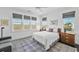 Cozy bedroom with soft textures, three windows, stylish decor, and a patterned rug at 1518 Bower Ln, Johns Island, SC 29455