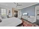 A primary bedroom features a ceiling fan, blue accent wall, closet, and decorative rug at 1518 Bower Ln, Johns Island, SC 29455