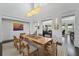 Open-concept dining room with a large wooden table, modern light fixture, and neutral decor at 1518 Bower Ln, Johns Island, SC 29455
