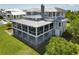 Aerial view of the backyard and exterior of the home featuring a screened porch at 1518 Bower Ln, Johns Island, SC 29455