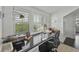 Bright home office with a black desk, white plantation shutters, and stylish adjustable lighting fixtures at 1518 Bower Ln, Johns Island, SC 29455
