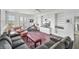 Spacious living room with a large gray couch, neutral chairs, a patterned rug, and built-in shelving at 1518 Bower Ln, Johns Island, SC 29455