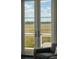 Comfortable seating with marsh views through glass doors leading to a deck or patio at 1518 Bower Ln, Johns Island, SC 29455