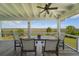 A covered patio with marsh views features a ceiling fan and a table with seating for four at 1518 Bower Ln, Johns Island, SC 29455