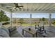 An outdoor porch with marsh views features a ceiling fan and seating at 1518 Bower Ln, Johns Island, SC 29455
