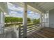 Beautiful porch view featuring a wood floor, white columns, and scenic views at 1518 Bower Ln, Johns Island, SC 29455