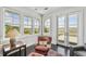 Cozy sitting area with comfortable seating, a view of the marsh through large windows and a French door at 1518 Bower Ln, Johns Island, SC 29455