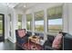 Intimate sunroom features comfortable chairs and large windows with scenic views at 1518 Bower Ln, Johns Island, SC 29455
