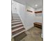 Basement stairway with wooden steps and landing area with wooden bench, shelf and hooks at 1518 Bower Ln, Johns Island, SC 29455