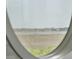 Marsh view seen through circular kitchen window at 1518 Bower Ln, Johns Island, SC 29455