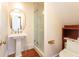 Elegant bathroom features a pedestal sink and a glass enclosed shower stall for a clean aesthetic at 155 Wentworth St # A, Charleston, SC 29401