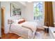 Bright bedroom with a large window, stylish decor, and hardwood floors offering a comfortable retreat at 155 Wentworth St # A, Charleston, SC 29401