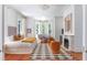 Bright bedroom with a fireplace, seating area, and large windows offering plenty of natural light at 155 Wentworth St # A, Charleston, SC 29401