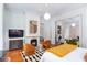Bright bedroom featuring fireplace, hardwood floors, modern art, and sitting area in a luxurious space at 155 Wentworth St # A, Charleston, SC 29401