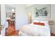 Cozy bedroom featuring a large window, stylish decor, and hardwood floors, adjoining to the kitchen at 155 Wentworth St # A, Charleston, SC 29401