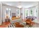 Luxurious bedroom with a seating area, featuring hardwood floors, large windows, and elegant decor at 155 Wentworth St # A, Charleston, SC 29401