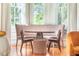 Bedroom seating area with a modern table and chairs set in front of large windows with natural light at 155 Wentworth St # A, Charleston, SC 29401