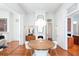 Bright dining room with a round table, white chairs, and classic white fireplace, perfect for entertaining at 155 Wentworth St # A, Charleston, SC 29401