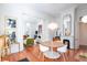 Elegant dining room featuring hardwood floors, statement lighting, and seamless flow into the living room at 155 Wentworth St # A, Charleston, SC 29401