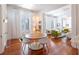 Dining area featuring a wooden table, white chairs, a wet bar, and large windows for natural light at 155 Wentworth St # A, Charleston, SC 29401