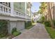 Home exterior view featuring manicured landscaping and brick driveway at 155 Wentworth St # A, Charleston, SC 29401