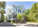 Charming home with a bright exterior, multiple porches, and lush tropical landscaping at 155 Wentworth St # A, Charleston, SC 29401