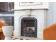 Ornate fireplace with stone surround and vintage black metal insert, flanked by stylish furniture at 155 Wentworth St # A, Charleston, SC 29401