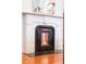 Elegant fireplace with white mantle and a decorative black iron surround adds charm to this home at 155 Wentworth St # A, Charleston, SC 29401