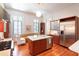 Spacious kitchen with stainless steel appliances, marble island, and seamless transition to sitting area at 155 Wentworth St # A, Charleston, SC 29401