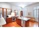 Well-appointed kitchen featuring stainless steel appliances, custom cabinets, marble island, and hardwood floors at 155 Wentworth St # A, Charleston, SC 29401