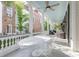 Inviting porch with white columns, ceiling fan, and a comfortable seating area, great for outdoor relaxation at 155 Wentworth St # A, Charleston, SC 29401