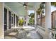 Charming front porch with white columns, ceiling fan, and a delightful seating arrangement for enjoying the outdoors at 155 Wentworth St # A, Charleston, SC 29401